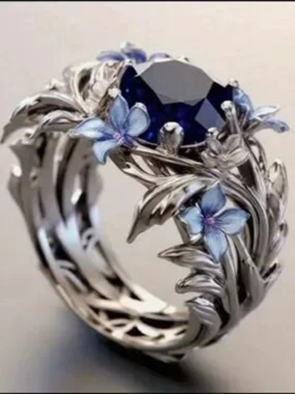 Silver Ring with Deep Blue Center and Blue Floral Accents